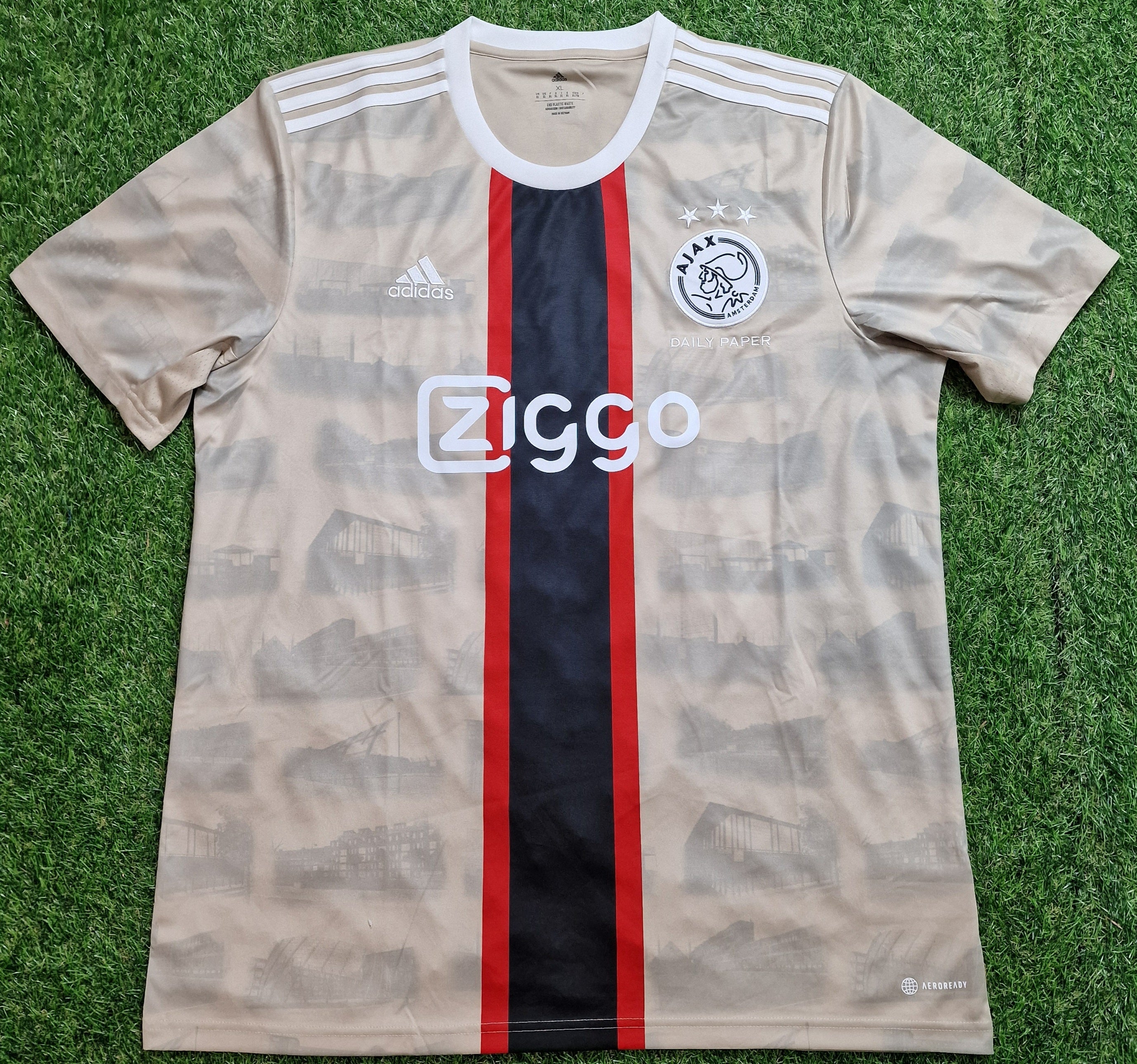 Sand brown Ajax Amsterdam X Daily Paper Football Shirt Third 22/23, featuring iconic club crest and sponsor logos, perfect for showing your support on and off the pitch.